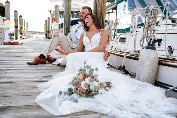 Newly weds are laughing and having fun while taking photos near Bradenton Beach