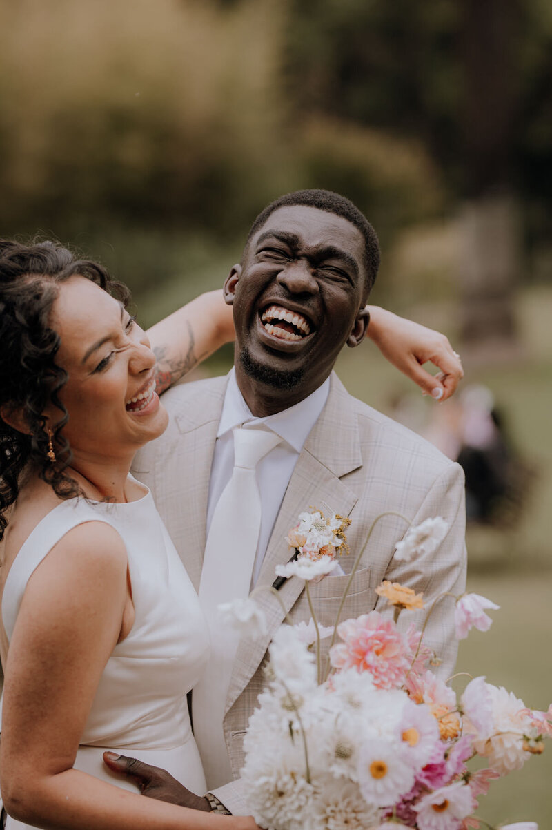 Bride and groom holding each other and laughing