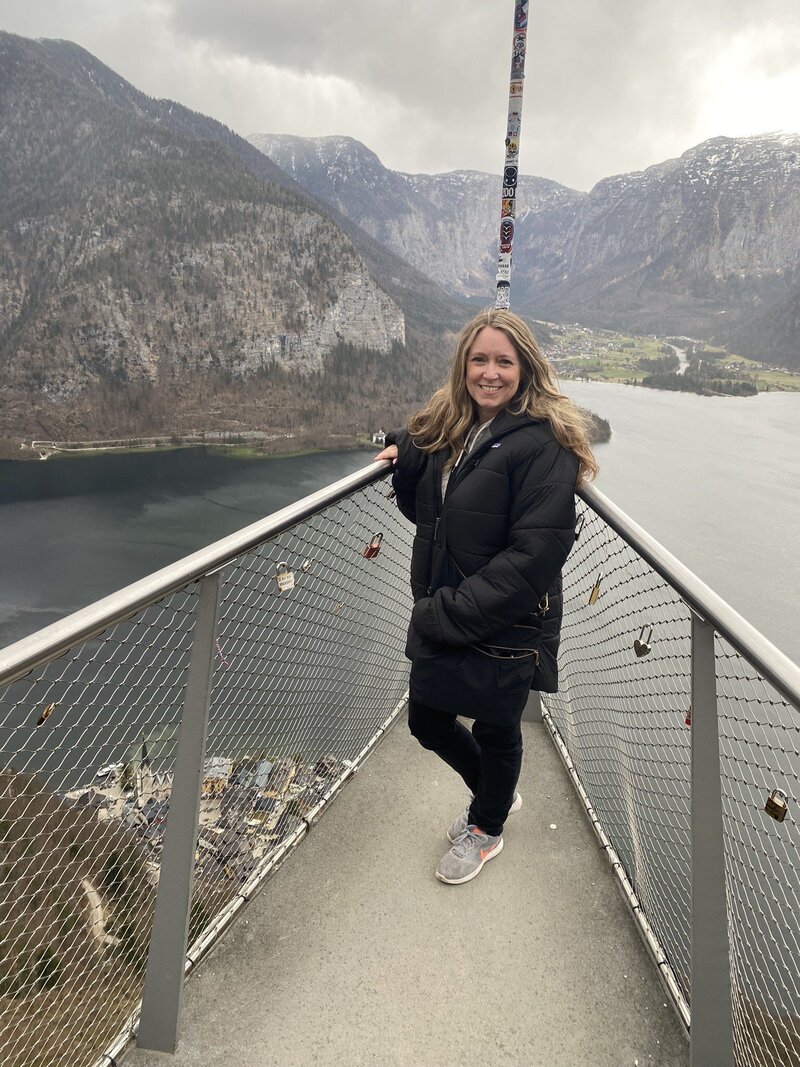 Terra Brown from Adventures by Terra standing on the Halstatt Skywalk in Halstatt, Austria