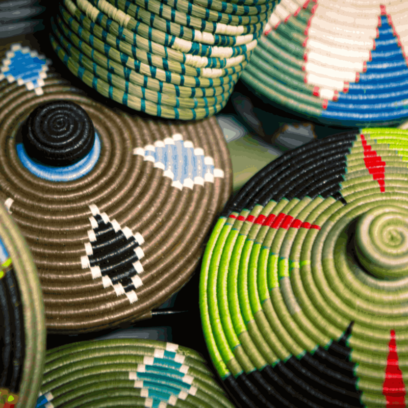 Man walking in dusty road lined with Baobob trees