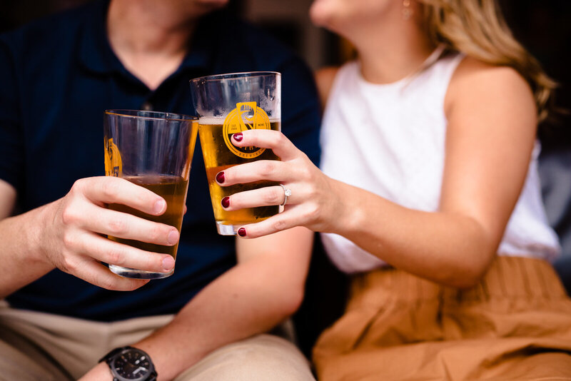 Engaged couple enjoys beers during their Raleigh engagement photo session