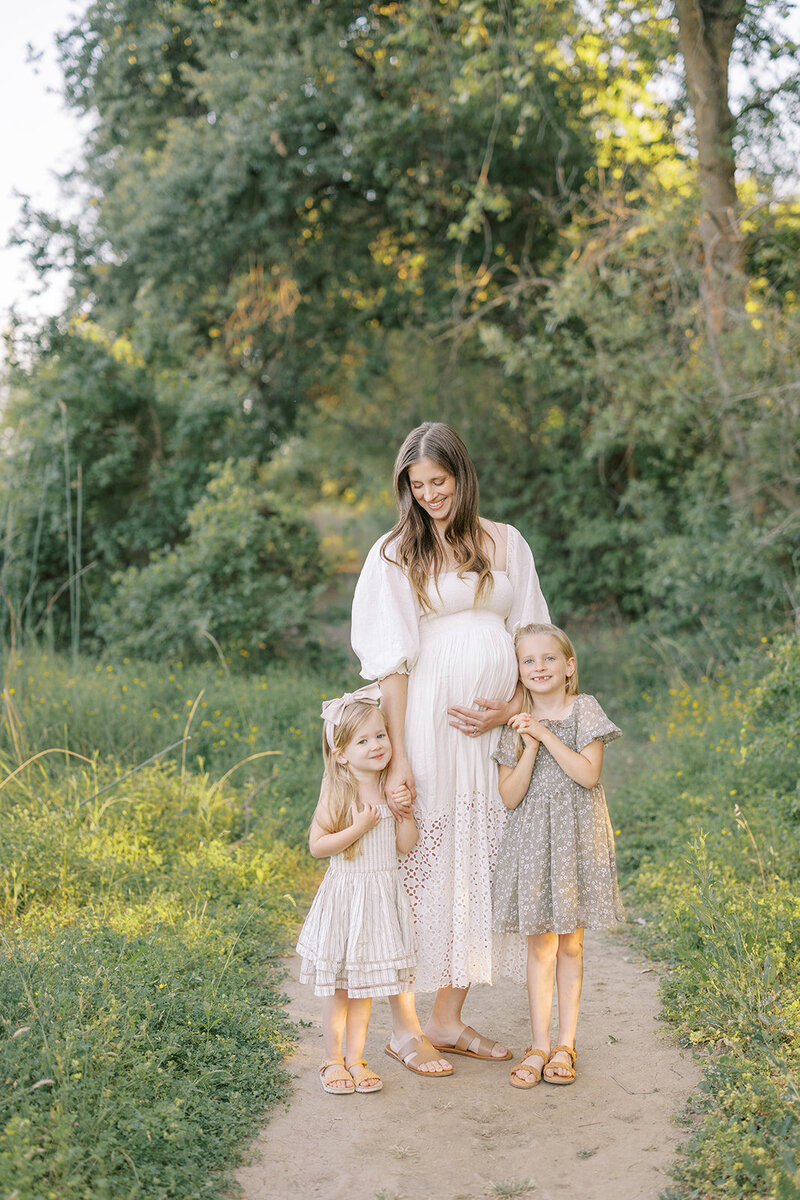 mom kidding toddler girl in vineyard; mom wearing Petal and Pup dress