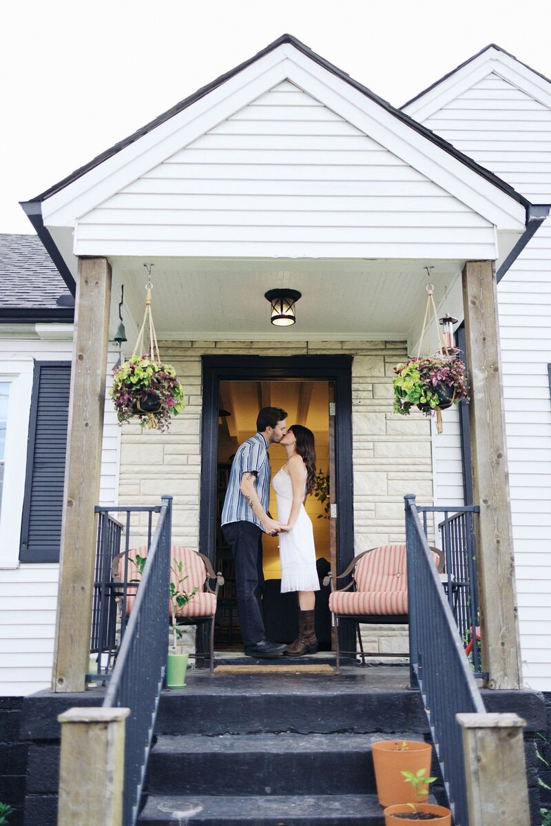 couple kissing on porch in middle Tennessee taken by photographer