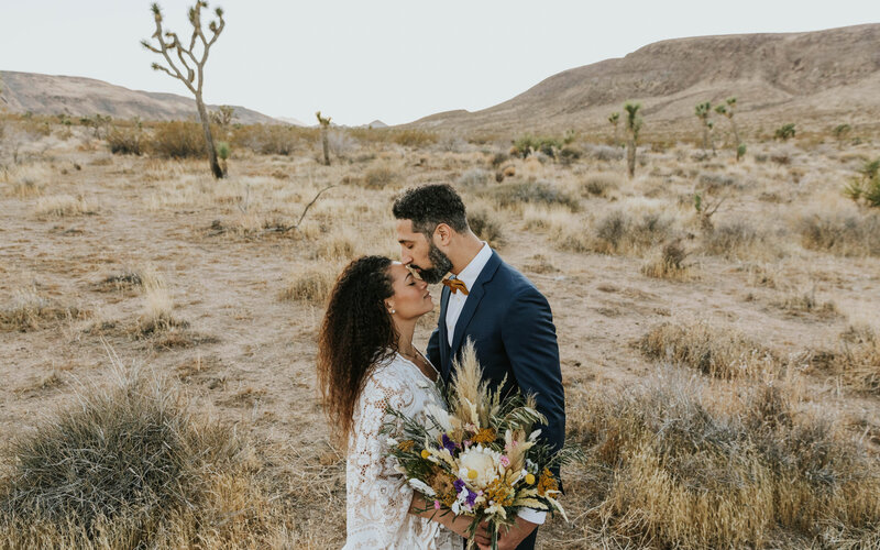 groom kissing bride on her forehead