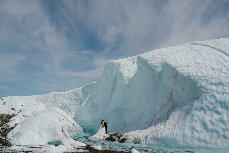 Couple kissing during their glacier elopement in Alaska.