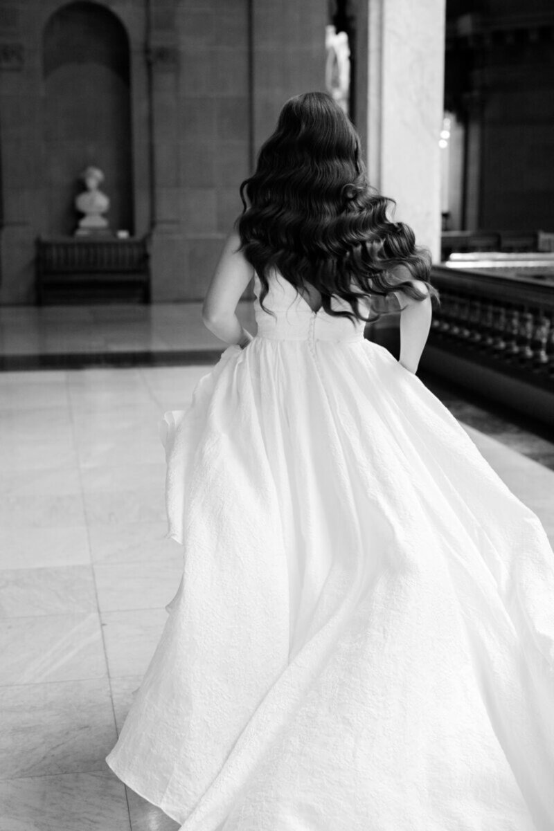 Wedding photography in Cincinnati of bride running in a hallway