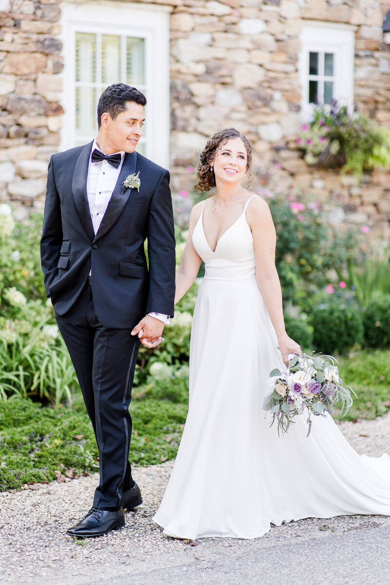 Bride & Groom walking together smiling at each other