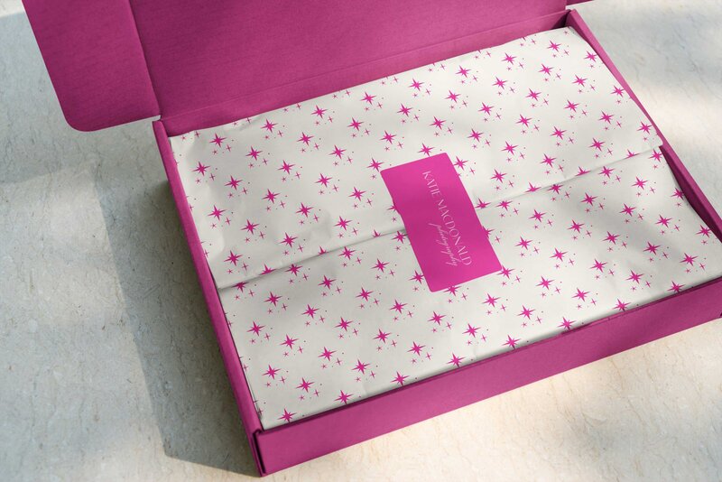 A box with branded tissue paper for Katie MacDonald Photography