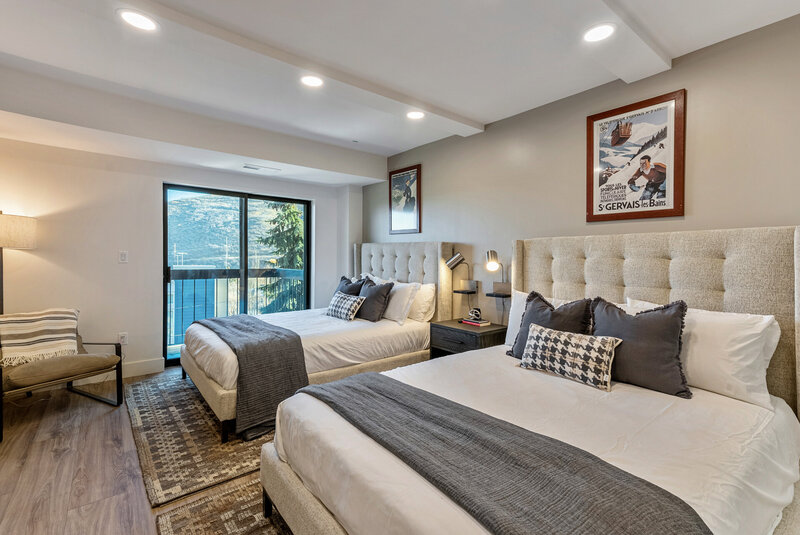 Cozy two-bed bedroom design by vacation home interior designer Chalet + Co.