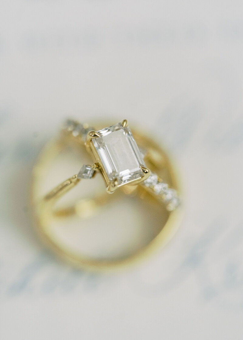 a close up of a gold wedding ring with a large diamond