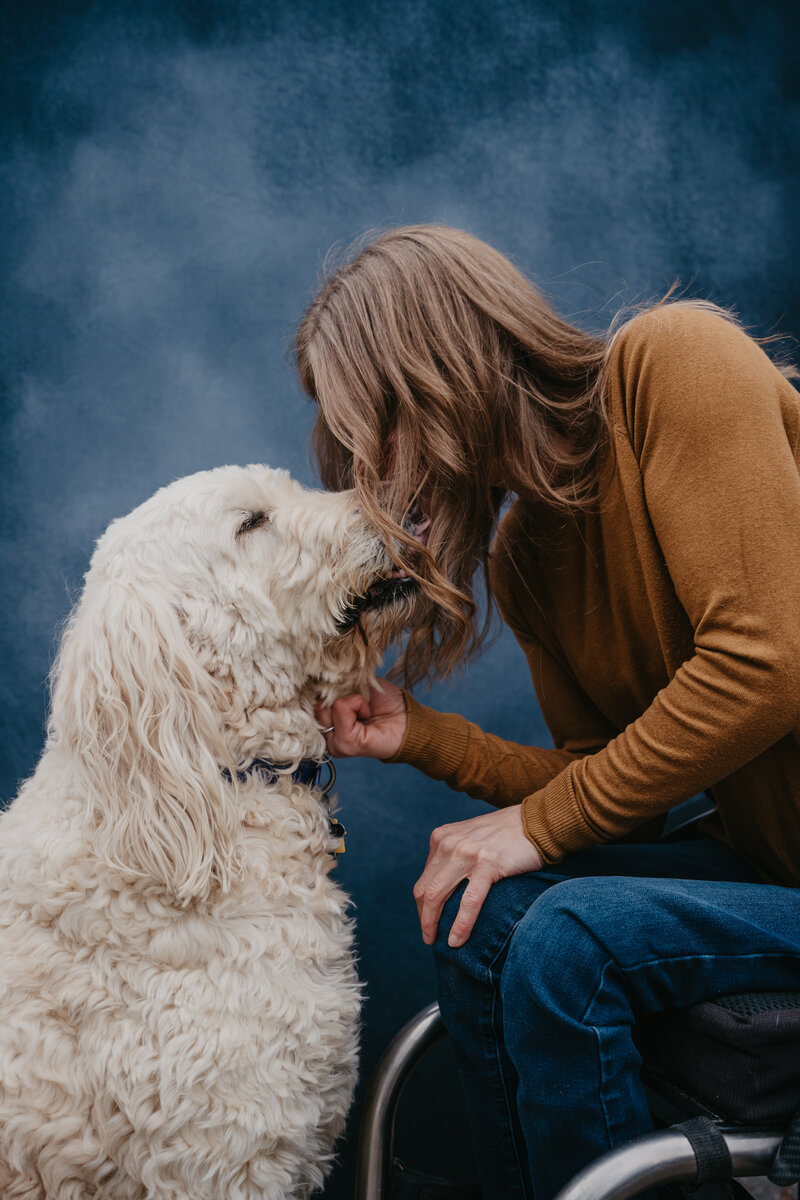 Beth Requist, custom web designer, beth in wheelchair petting dog