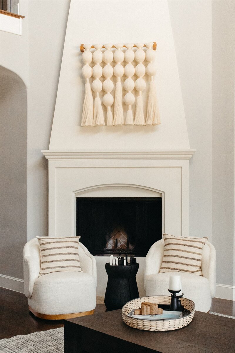 Bright room with a minimally decorated fireplace seating area, designed by Hope Miriam Designs in DFW