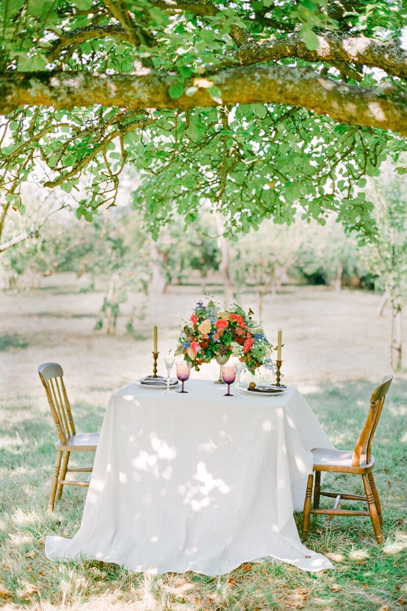 A romantic table set in the apple orchard at the Anne Cottage