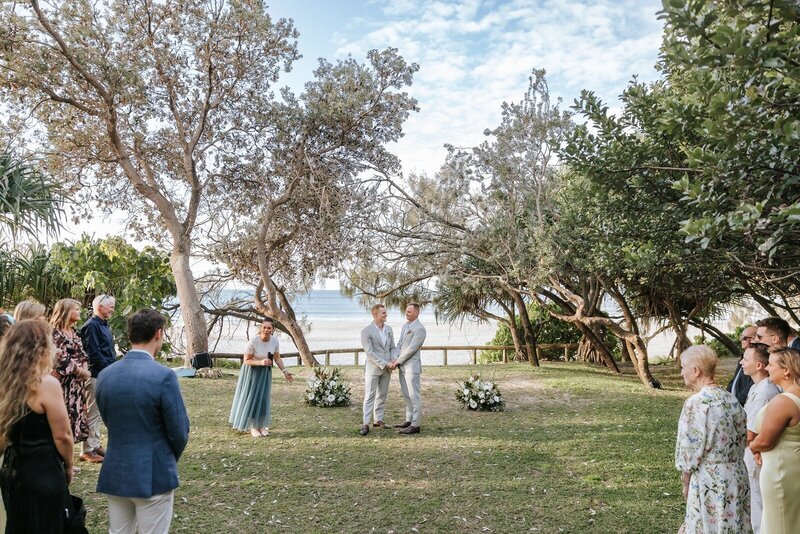 A bride and groom kissing at Noosa Boathouse