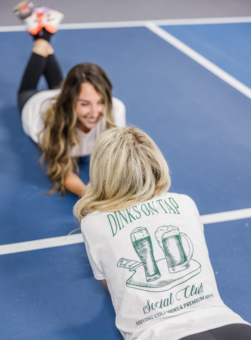 pickleball rackets resting against a net. image credit aleksander-saks unsplash free for use