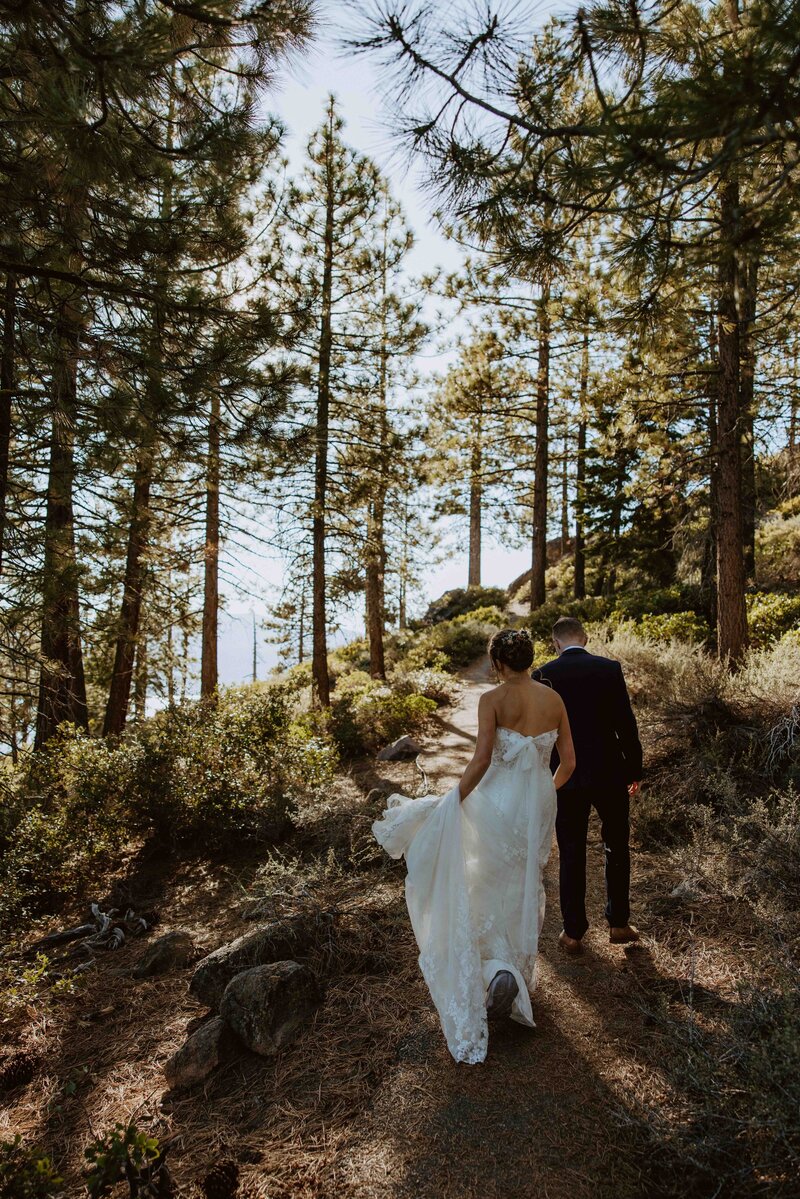 Couple hiking to their adventure elopement ceremony in Lake Tahoe