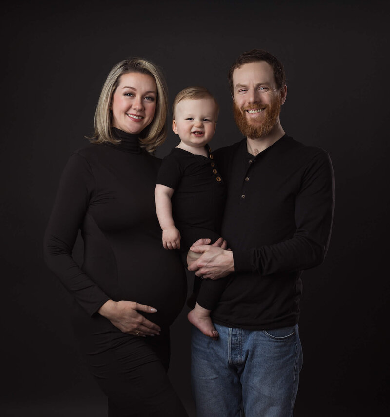 martenity family with toddler all wearing black