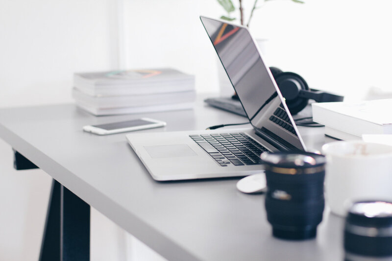 Laptop and coffee cup on a clean workspace