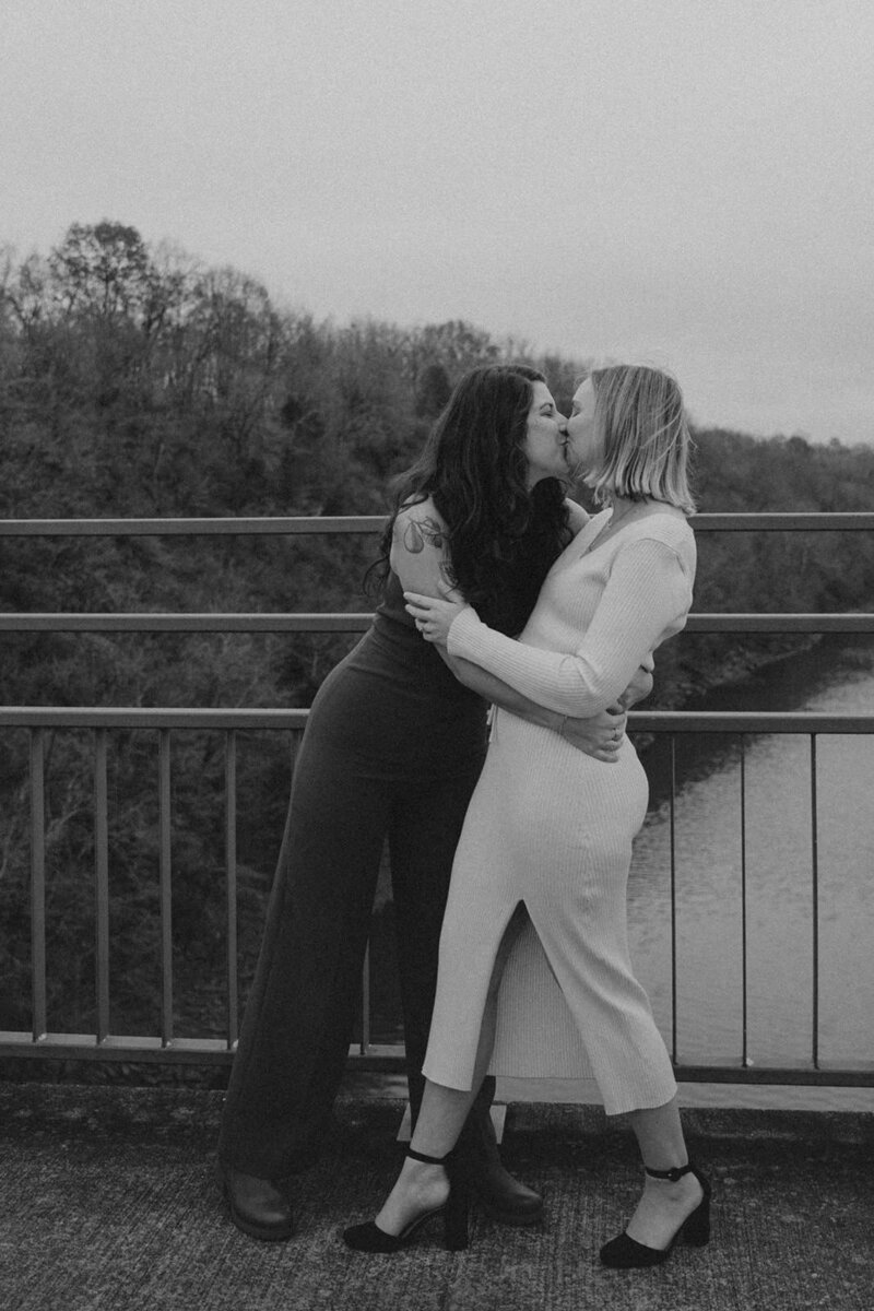 Woman leans in for a kiss with her new wife on a Nashville Tennessee bridge 