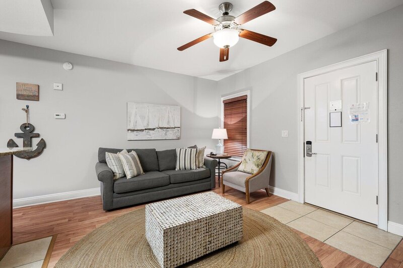 living room with grey couch and chair