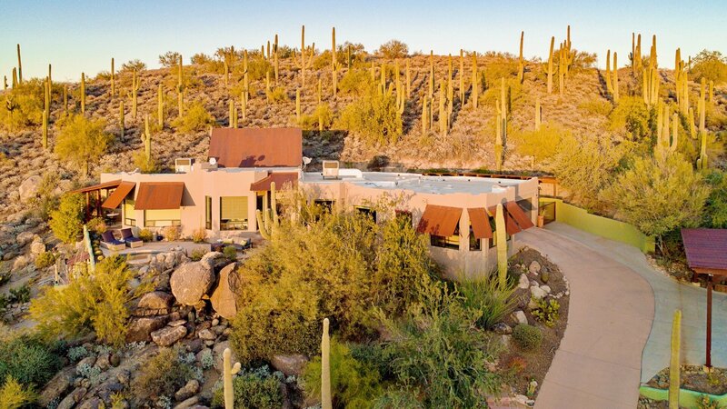 Aerial image of a modern desert home on a saguaro-studded hillside in Cave Creek.