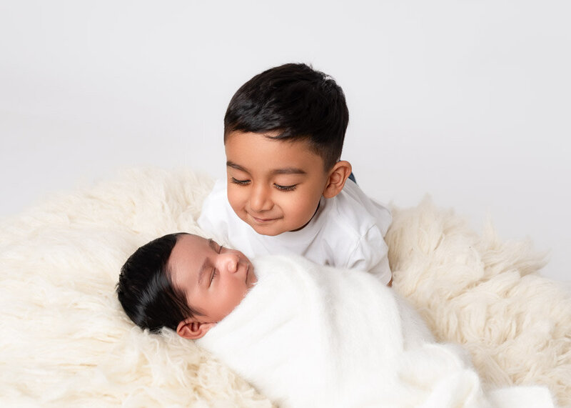 older-sibling-looking-at-newborn-baby-portrait-10