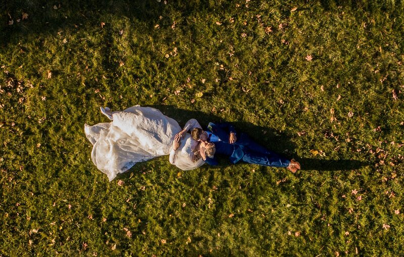 Bride and Groom laying on ground, aerial photo | Maine Wedding Photography