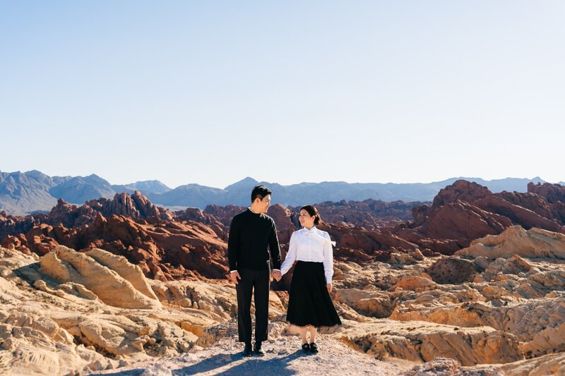 Couple holding hands while enjoying  the views at Valley of Fire in Las Vegas.