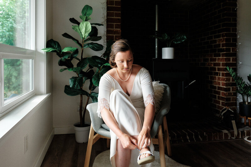 Bride places her shoes on