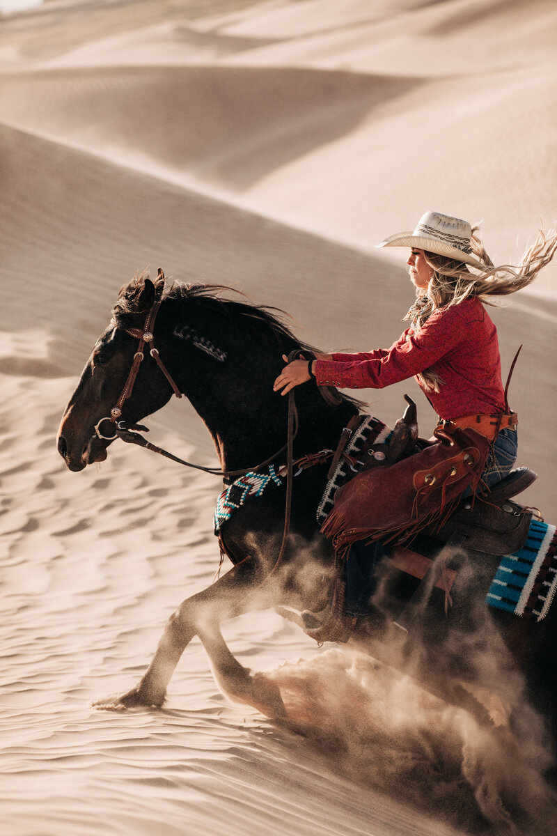 woman holding a camera next to her horse