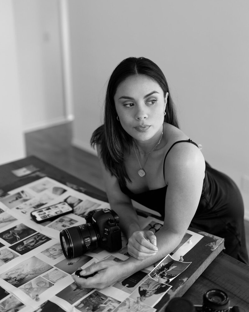 Malaya Lewandowski, fine art wedding photographer in Santa Barbara, smiling with camera in hand