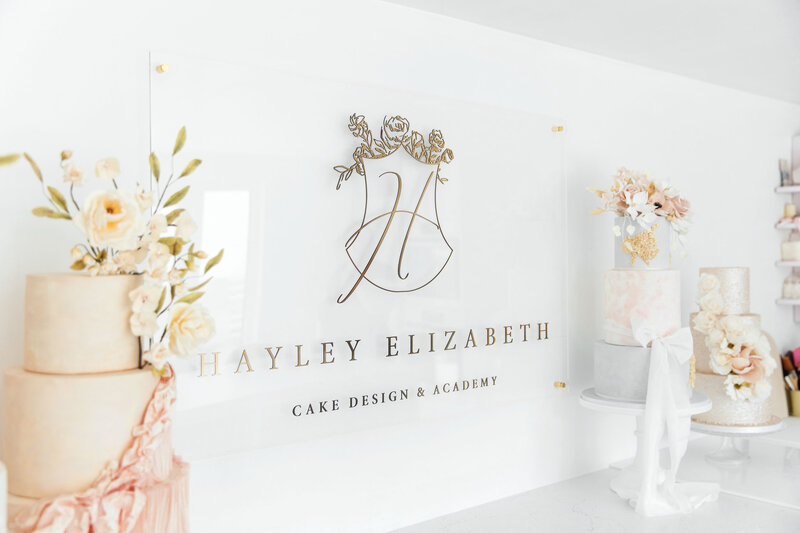 Gold brand signage installed inside the Hayley Elizabeth cake studio — part of her full rebrand