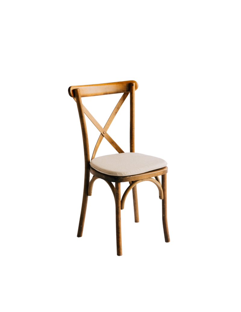 Natural wood Crossback chair with ivory cushion shown against a dark backdrop.
