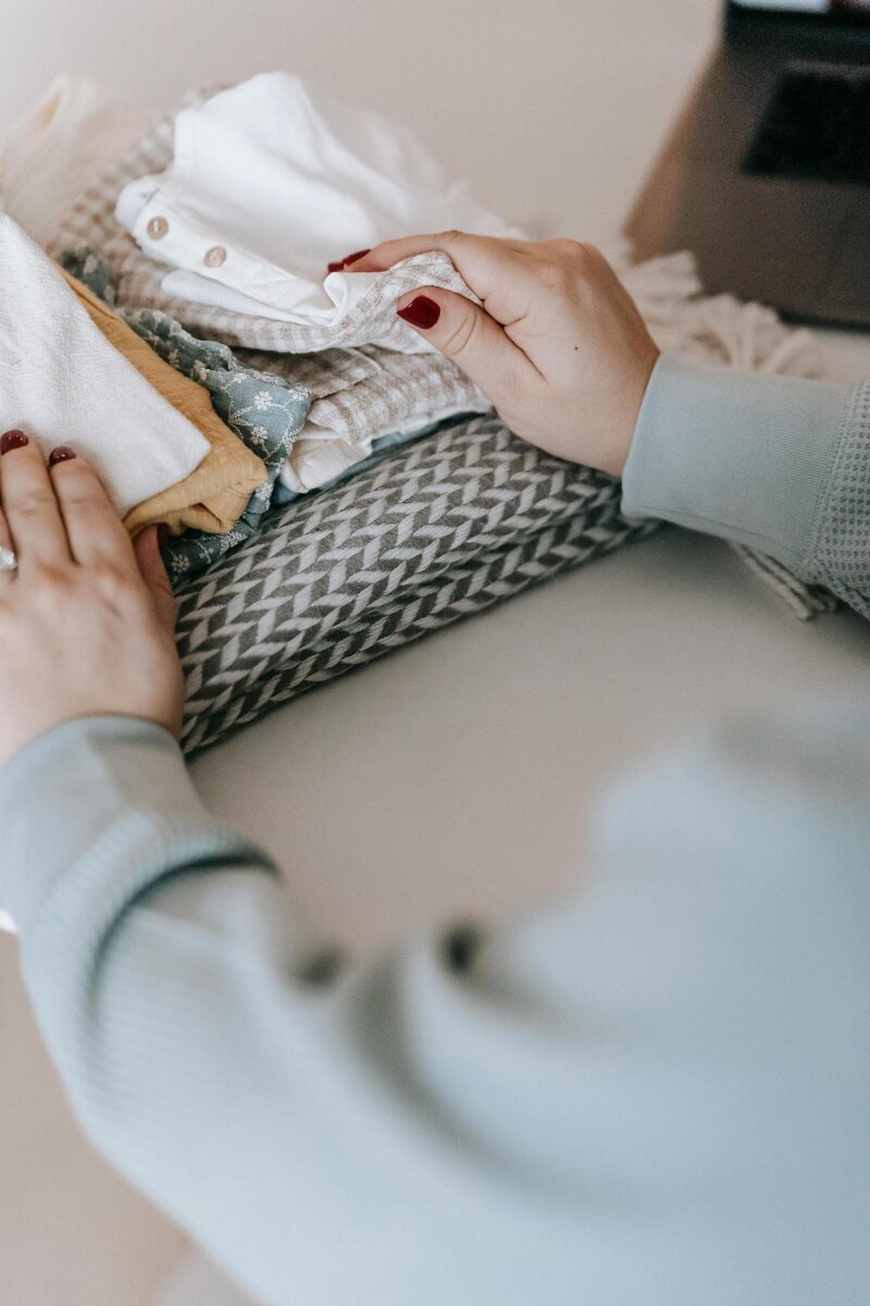 Woman folding clothes into a neat pile