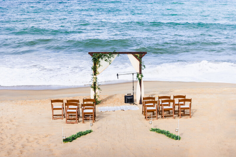 wedding arch and chairs on the beach