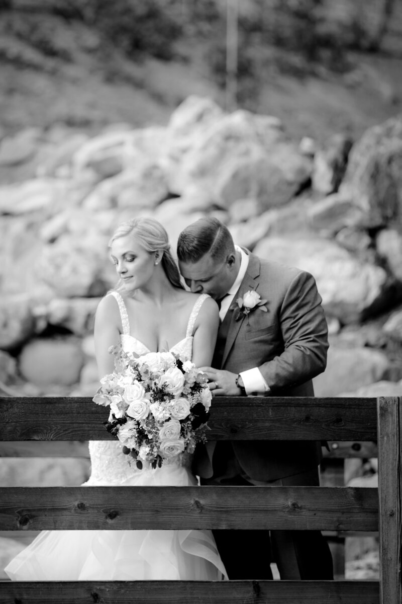 Weddings in Newport Beach bride and groom standing on wood bridge
