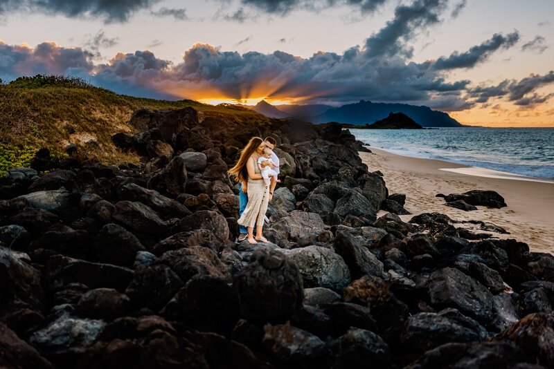 couple laughing holding hands in sand dunes