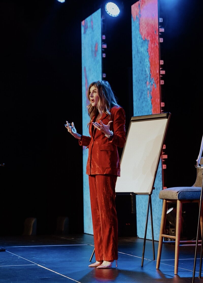 Macy McNeely presenting to an audience at the Marketing Matters summit