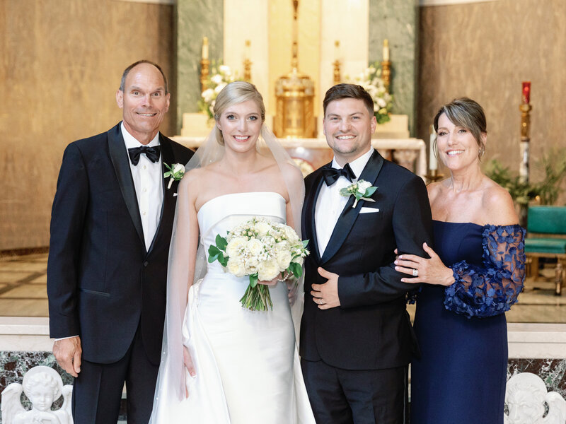 modern bride and groom with the father of the groom and mother of the groom