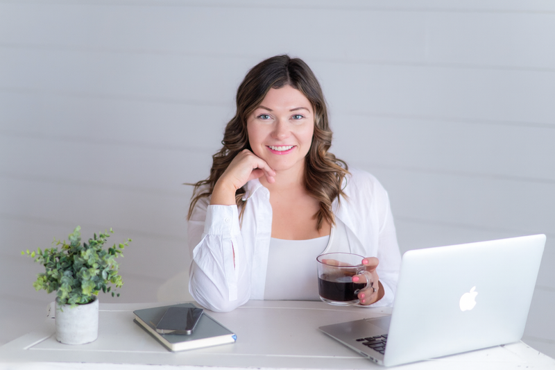Sarah Hawk, web designer, posing at desk with laptop and coffee