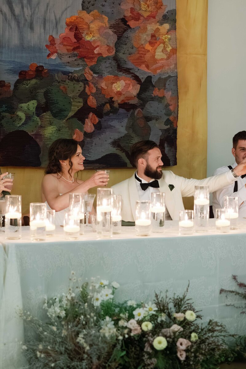 Wedding party portrait in Scottsdale, Arizona. Bride and groom walk hand in hand alongside wedding party.