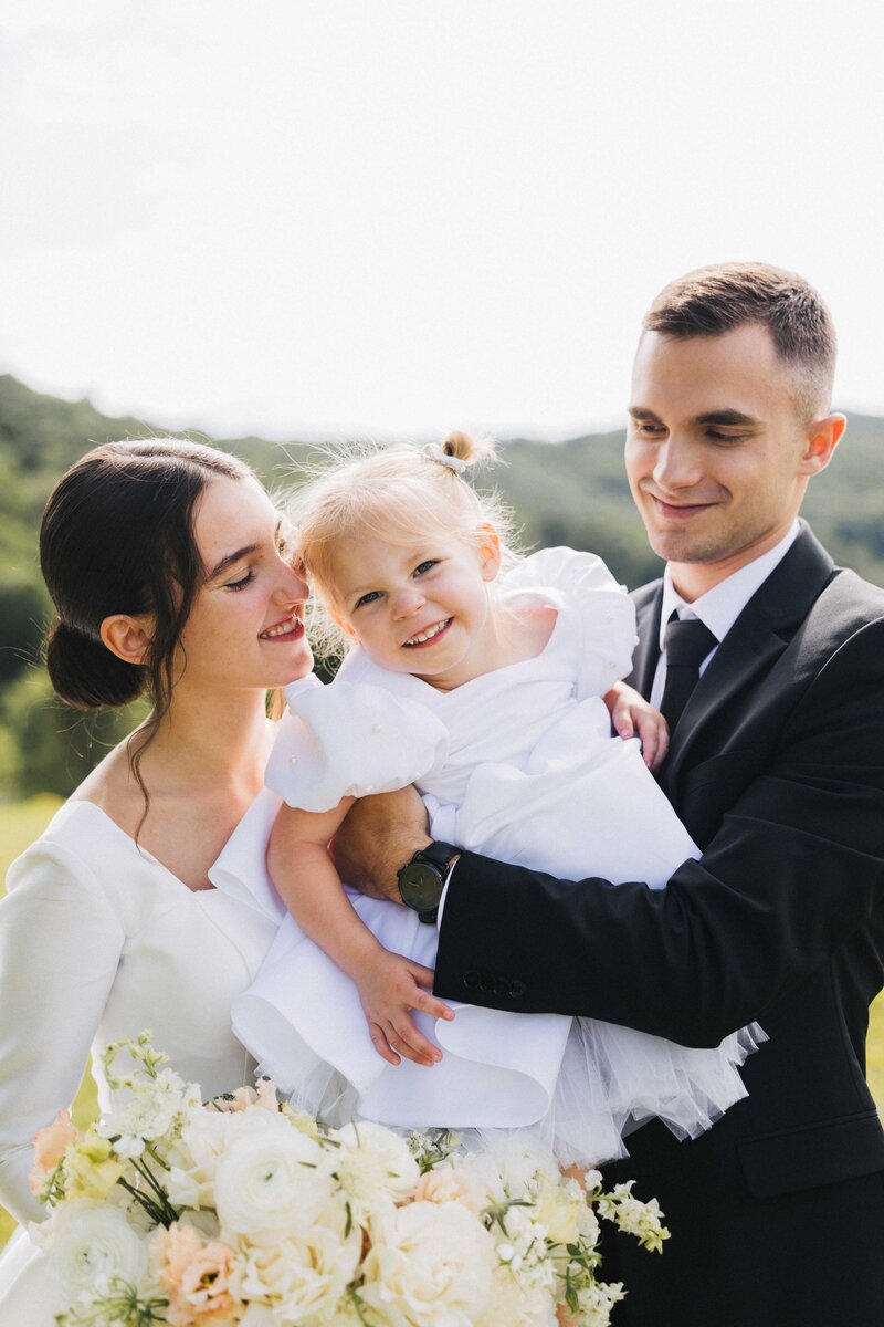 bride and groom with the flower girl