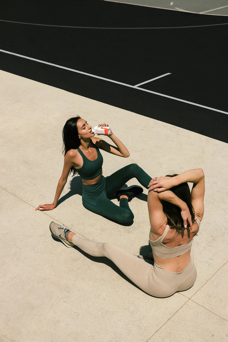 Athlete in post-workout recovery using foam rolling and hydration for muscle care and restoration