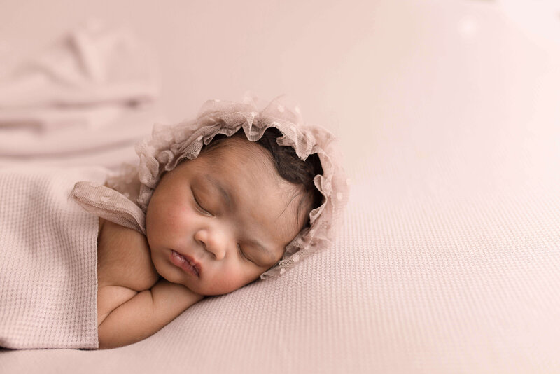 Newborn on Mauve in studio