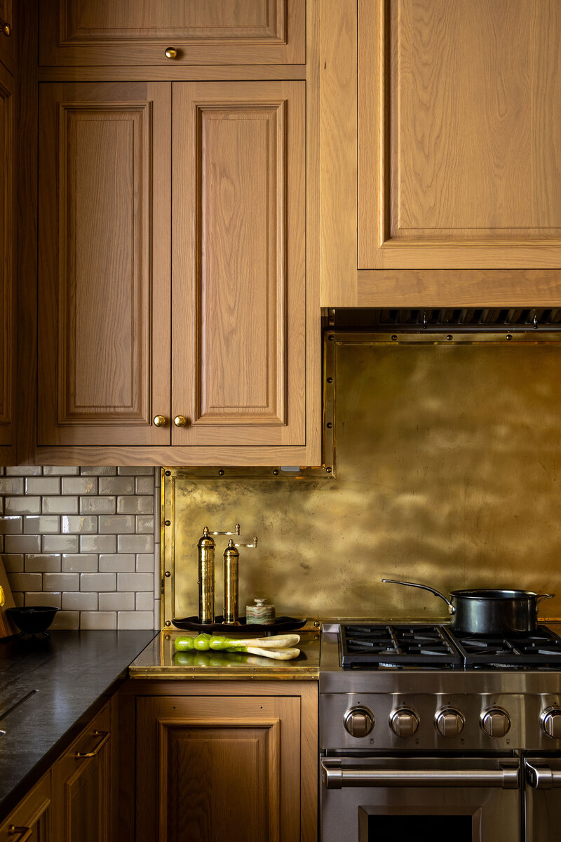 Brass black splash, white oak cabinets