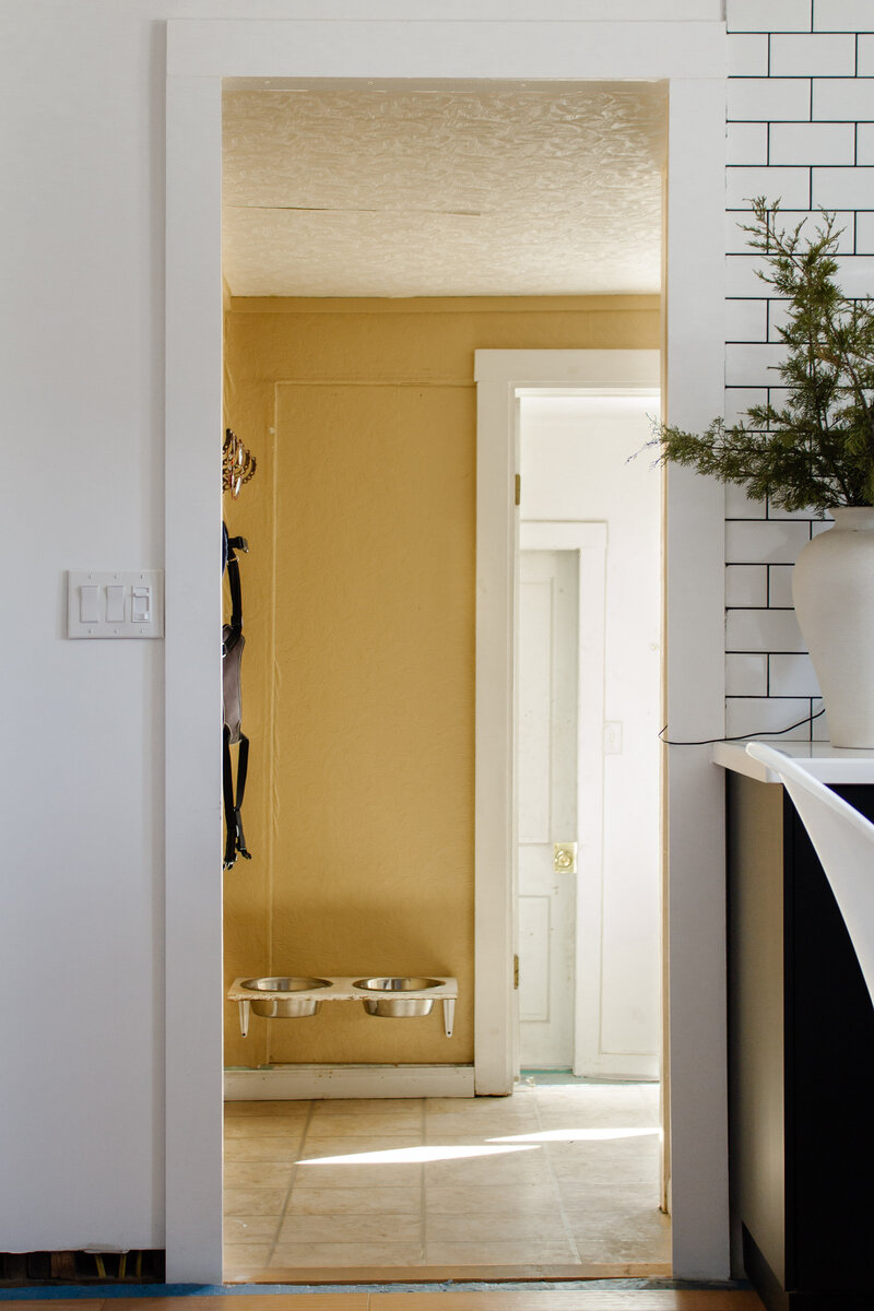 Laundry Room renovation by Nadine Stay. Rustic dark wood walls with basketweave brick floors. Brown door paint color. Mudroom built in cabinets.