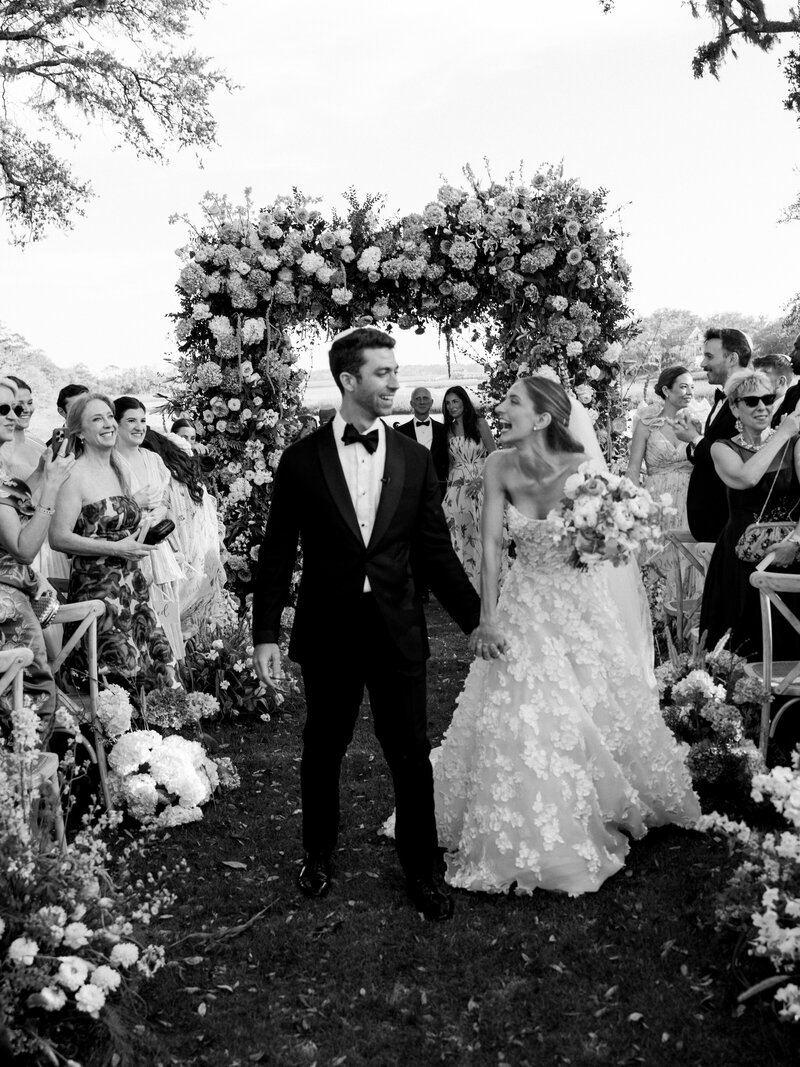 Bride in Monique Lhuillier walks with her father down the aisle at her wedding in Ravello at Villa la Rondinaia
