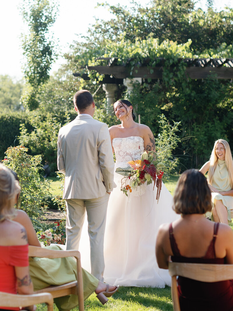 bride and groom kiss at the altar