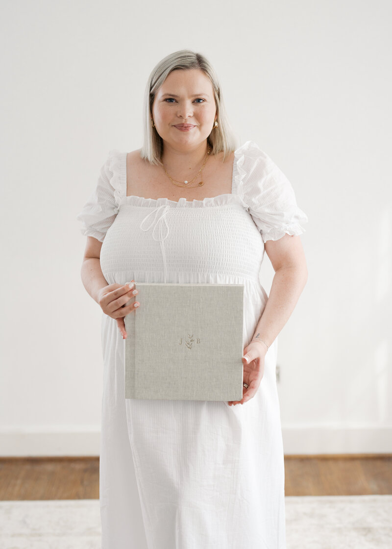 woman holding a fine art album