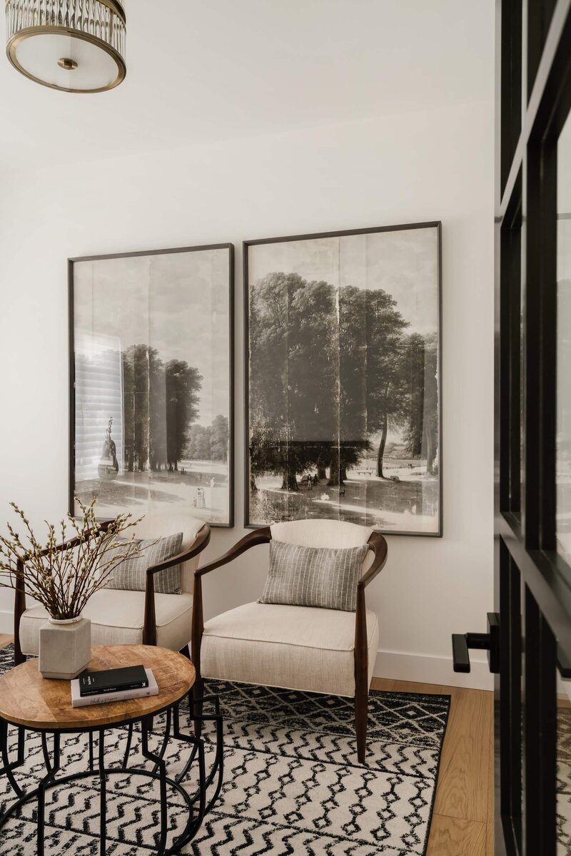 A home office with reading area and oversized meadow artwork.